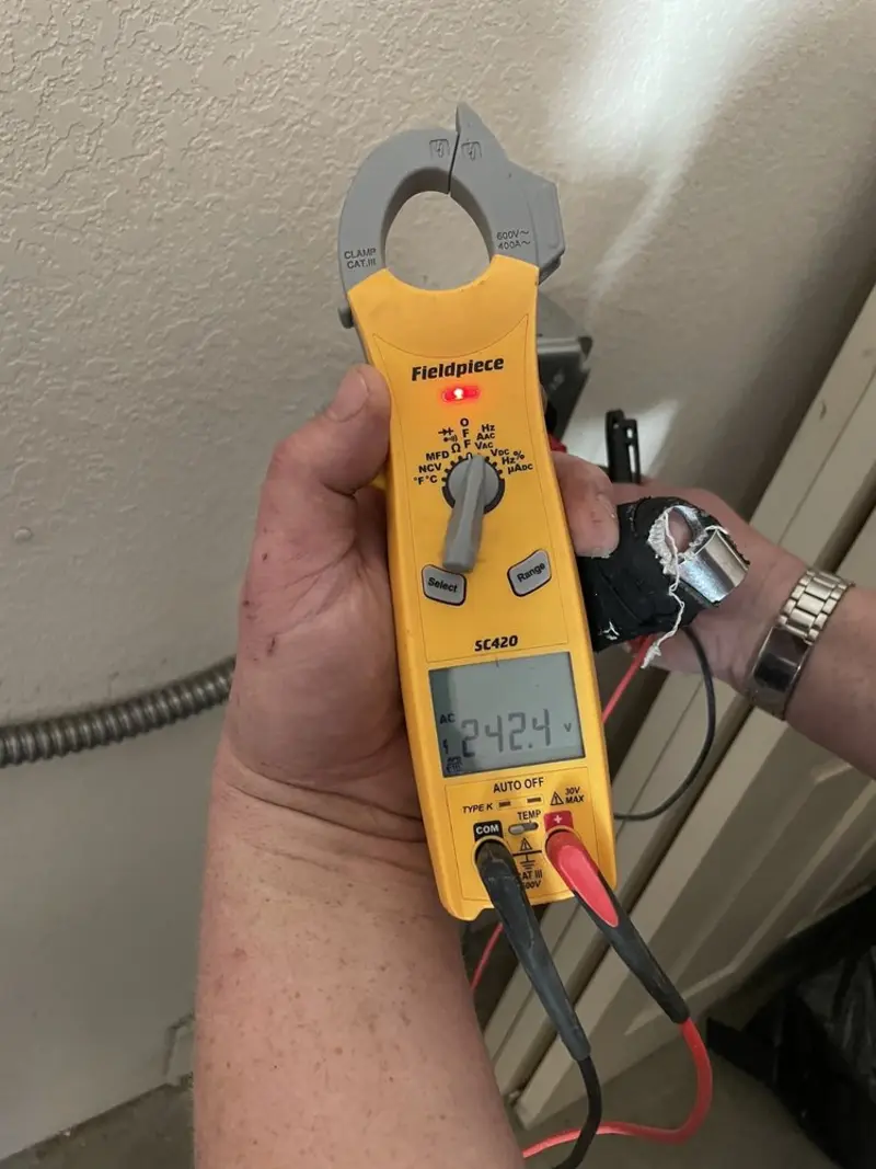 Voltage testing with clamp meter during Electrical Installation Services in San Castle